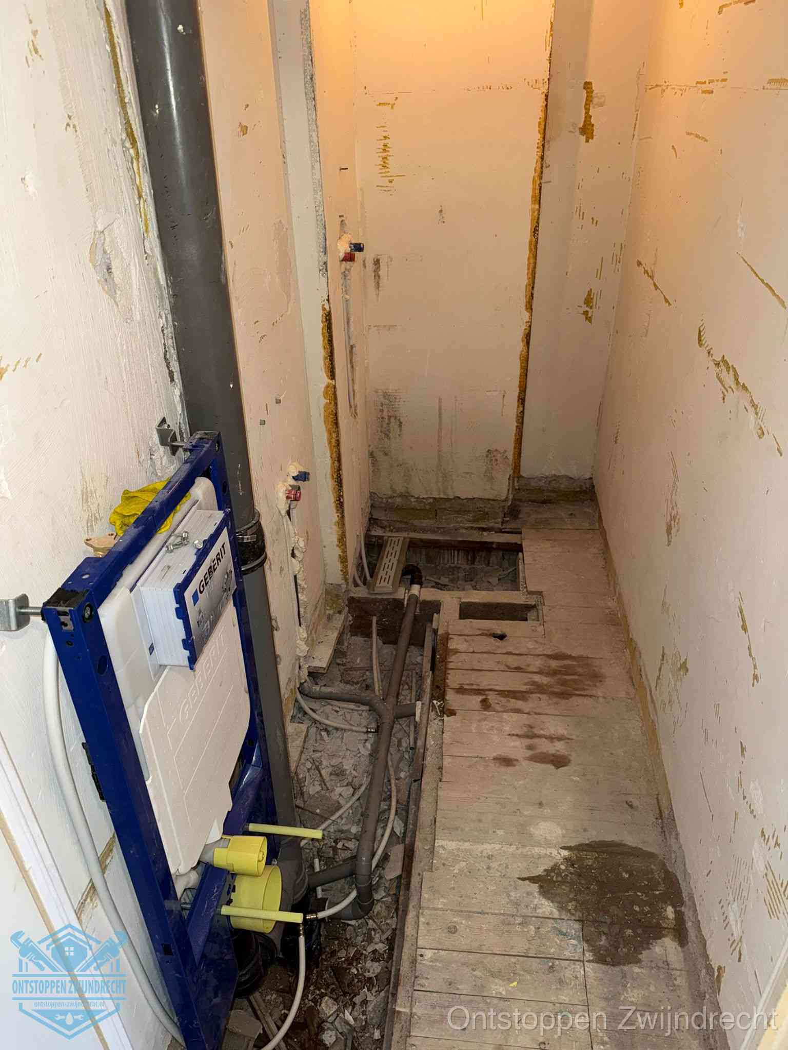 Een opgebroken toiletruimte tijdens renovatie met een Geberit inbouwreservoir en blootliggende oude afvoerleidingen, typisch voor oudere woningen in Zwijndrecht